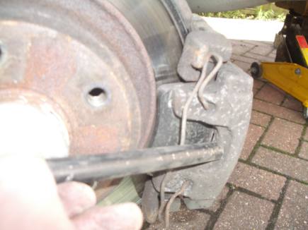 tapping the centre of the brake clliper